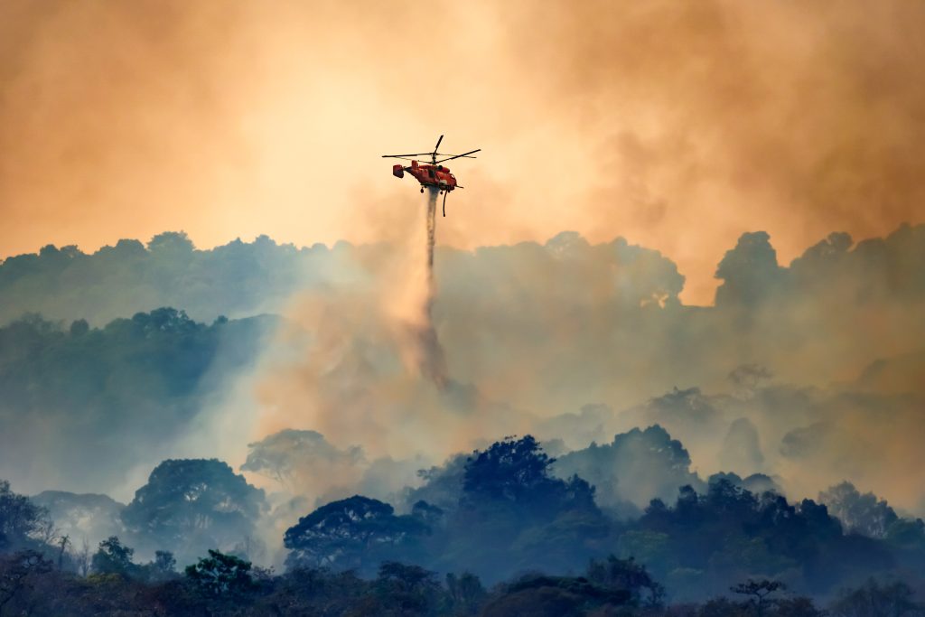 Helicopter assisting firefighting efforts during a wildfire