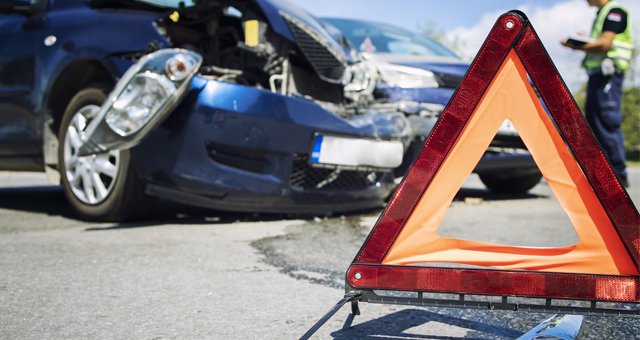 A car collision with a warning sign