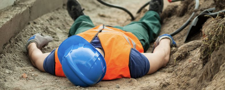 Construction worker lying on ground after accident