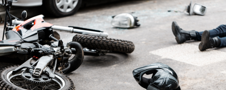 Motorcyclist lying on ground after accident