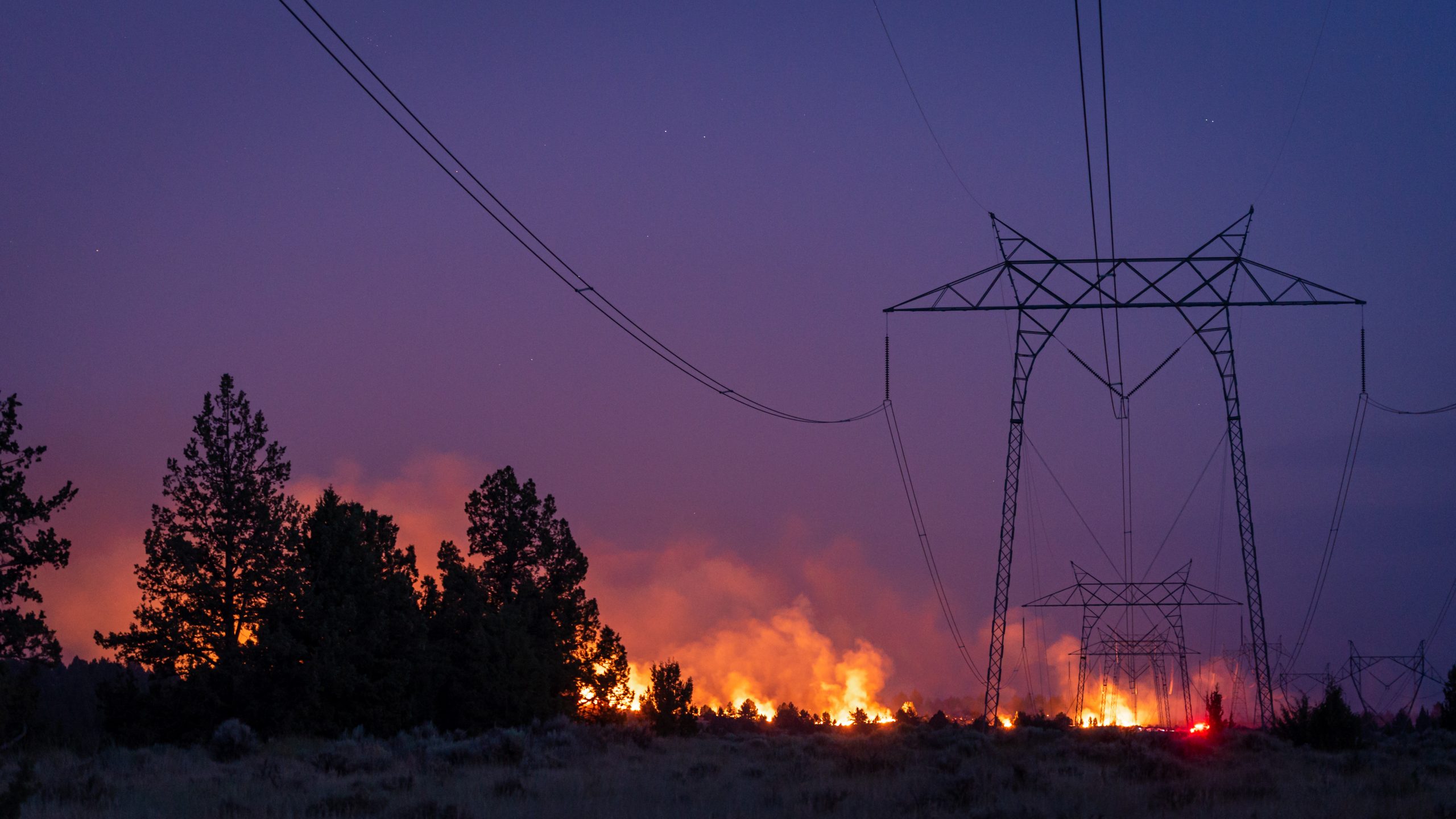 California wildfire burns under power lines